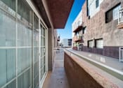 Thumbnail 9 of 75 - A long, narrow alleyway between two buildings with balconies.