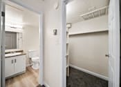 Thumbnail 12 of 18 - A bathroom with a toilet, sink, and mirror.