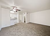 Thumbnail 9 of 18 - A room with a ceiling fan and carpeted floor.
