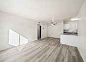 Thumbnail 6 of 18 - A room with wooden flooring and a ceiling fan.
