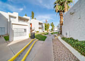 Thumbnail 5 of 18 - A white building with a yellow line in front of it.