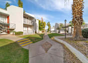 Thumbnail 6 of 18 - A sunny day at the apartment complex with a clear blue sky.
