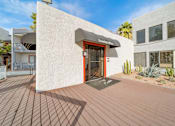 Thumbnail 2 of 18 - A building with a red door and a sign that says "Leasing Office".
