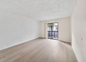 Thumbnail 8 of 18 - A room with a white brick wall and wooden floor.
