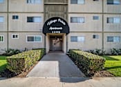 Thumbnail 2 of 5 - The front of a building with a sign that says "Village Police Apartments 13300".