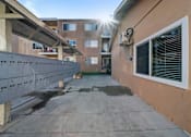 Thumbnail 4 of 5 - A sunny day at a residential area with apartment buildings and a clear sky.
