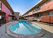 Thumbnail 9 of 12 - A small pool in a courtyard surrounded by a black fence.