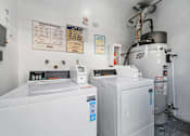 Thumbnail 4 of 4 - A white industrial machine sits in a room with a white wall and a sign that says "OPERATION INSTRUCTIONS" on the wall.