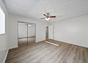 Thumbnail 4 of 10 - A room with a ceiling fan and a sliding door.