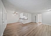 Thumbnail 3 of 10 - A room with wooden flooring and white walls.