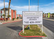 Thumbnail 21 of 21 - A sign for Sonoma Hills Apartment Homes stands in front of a street.