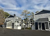 Thumbnail 3 of 25 - a row of houses with a parking lot