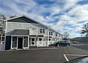 Thumbnail 4 of 25 - a building with a car parked in front of it