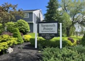 Thumbnail 1 of 25 - a sign for yarmouth pointe apartment homes in front of a garden