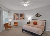 Thumbnail 4 of 14 - Bedroom with bed and ceiling fan  at Harrison Grande, Cary, NC, 27513