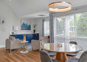 Thumbnail 8 of 14 - Living room with a table and chairs and a large window  at Harrison Grande, Cary, 27513