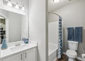 Thumbnail 8 of 27 - A white bathroom with a blue vase on the sink at The Atlantic Canton Ridge, Georgia