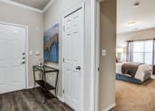 Thumbnail 11 of 25 - a bedroom with two closets and a door to a room with a bed at Village of Hawks Creek Apartments, Westworth Village