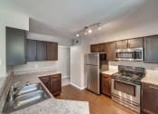 Thumbnail 8 of 16 - Open kitchen with stainless steel appliances and granite counter tops at Palazzo, San Marcos