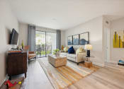 Thumbnail 3 of 18 - Living room of an apartment with a couch and a tv at The Atlantic at Tradition, Port St Lucie, Florida