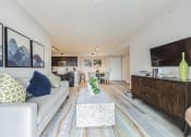 Thumbnail 4 of 18 - Living room with a couch and a coffee table and a tv at The Atlantic at Tradition, Port St Lucie, FL, 34987