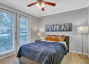 Thumbnail 13 of 17 - Bedroom with a bed and a ceiling fan at Vintage Park Apartments, Houston, TX 77070