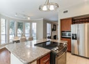 Thumbnail 17 of 17 - Kitchen with granite counter tops and stainless steel appliances at Vintage Park Apartments, Houston
