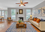 Thumbnail 16 of 17 - Living room with a couch and a coffee table and a fireplace at Vintage Park Apartments, Houston, Texas