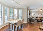 Thumbnail 15 of 17 - Dining room with a table and chairs and a living room with windows at Vintage Park Apartments, Houston, 77070