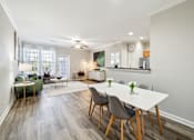 Thumbnail 16 of 23 - A dining room with a white table and chairs at The Atlantic Stone Oak Apartments, San Antonio