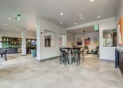 Thumbnail 2 of 12 - Clubhouse with a dining area and a bar with chairs and tables at The Atlantic Highland Park, Texas