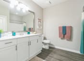 Thumbnail 12 of 15 - a bathroom with a large mirror and a sink and a toilet