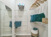 Thumbnail 11 of 15 - A white closet with shelves and baskets at The Atlantic North Highland, Charlotte