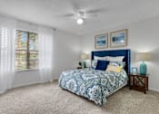 Thumbnail 12 of 23 - A bedroom with a bed, a ceiling fan, and a window with blinds at Boca Colony Apartments, Florida, 33433