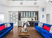 Thumbnail 6 of 23 - A living room with blue couches and a coffee table at Boca Colony Apartments, Boca Raton, Florida