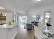 Thumbnail 1 of 23 - A modern living room with a glass table and white chairs at Boca Colony Apartments, Florida