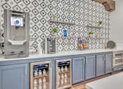 Thumbnail 6 of 13 - Kitchen bar with blue cabinets and a coffee machine at The Atlantic Mira Loma, Live Oak, 78233