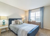 Thumbnail 6 of 18 - a bedroom with a bed and a window at Magnolia Terrace Apartments, Charlotte