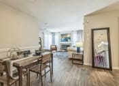 Thumbnail 4 of 18 - an open living room and dining room with a table and chairs and a mirror at Magnolia Terrace Apartments, North Carolina 28213