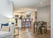 Thumbnail 2 of 18 - an open living room and kitchen with a dining room table and chairs at Magnolia Terrace Apartments, Charlotte, North Carolina