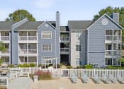 Thumbnail 17 of 18 - an image of an apartment building with chairs in front of it at Magnolia Terrace Apartments, Charlotte, NC, 28213