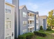 Thumbnail 16 of 18 - Apartment buildings with balconies and a clear sky in the background at Magnolia Terrace Apartments, Charlotte, 28213