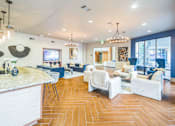 Thumbnail 26 of 34 - Resident lounge with a curved ceiling, hardwood floors, and a kitchen island  at The Atlantic Memorial, Houston
