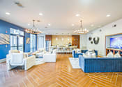 Thumbnail 25 of 34 - A living room with white furniture and a blue couch  at The Atlantic Memorial, Houston