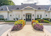 Thumbnail 18 of 24 - A white building with a black door and windows surrounded by flowers.at The Atlantic Canton Ridge, Canton  