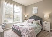 Thumbnail 6 of 24 - A bedroom with a bed, nightstand, and chair.at The Atlantic Canton Ridge, Canton, GA  