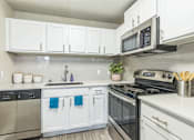 Thumbnail 2 of 19 - A kitchen with white cabinets at The Atlantic Loring Heights, Atlanta, Georgia