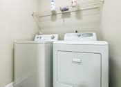 Thumbnail 10 of 19 - A  washing machine and dryer in a small laundry room at The Atlantic Loring Heights, Atlanta, Georgia