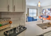 Thumbnail 11 of 13 - Kitchen and Living Room View  at The Atlantic Stonebriar, The Colony, TX, 75056