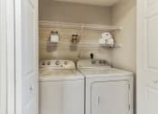 Thumbnail 8 of 18 - Laundry room is equipped with a washer and dryer at The Atlantic at Tradition, Port St Lucie